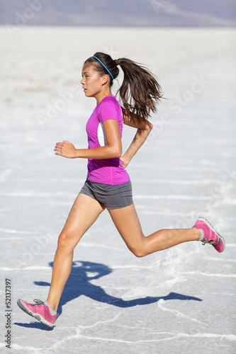 Photo: Running woman - runner sprinting on trail run Running woman - runner sprinting on trail run