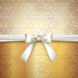 golden background with white bow