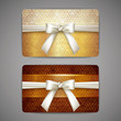 set of golden gift cards with white bows