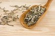 High quality green tea in wooden spoon close up