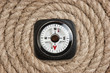 Foto: compass on old twisted rope compass on old twisted rope