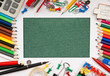 frame from a variety of office supplies and green paper for note