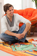 Young man playing a game at home
