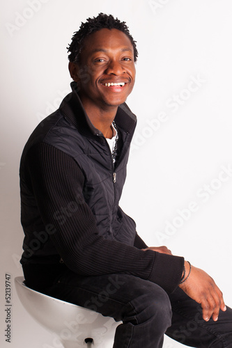 Photo: Handsome black guy sitting on a chair Handsome black guy sitting on a chair