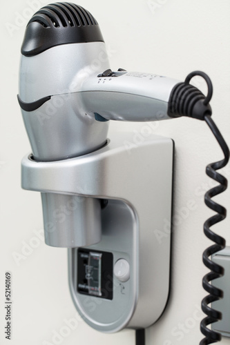 Photo: Hairdryer with cord attached to a wall Hairdryer with cord attached to a wall