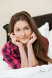 Photo: Cute young girl relaxing on the bed Cute young girl relaxing on the bed