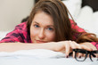 Photo: Cute young girl relaxing on the bed Cute young girl relaxing on the bed