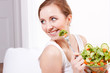 Photo: lachende junge frau isst gesunden salat lachende junge frau isst gesunden salat