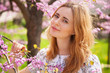 Photo: Beautiful woman in spring blossom Beautiful woman in spring blossom