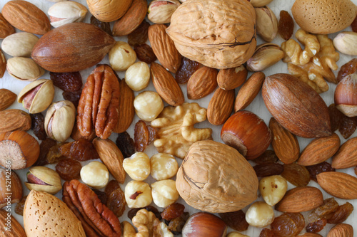 Photo: Selecion of nuts, almonds and sultanas, close up Selecion of nuts, almonds and sultanas, close up