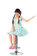 Photo: Happy little asian girl sitting on high chair Happy little asian girl sitting on high chair