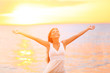 Freedom woman happy and free open arms on beach