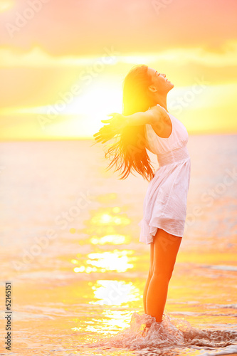 Photo: Free woman enjoying freedom feeling happy at beach Free woman enjoying freedom feeling happy at beach