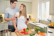 Couple enjoying drinking wine and cooking