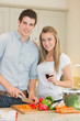 Smiling couple preparing dinner