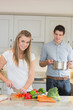 Foto: Woman cutting vegetables with man helping Woman cutting vegetables with man helping