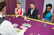 Man and two women playing poker