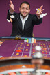 Photo: Man throwing chips onto roulette table Man throwing chips onto roulette table