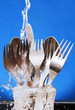 cutlery under running water.