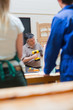Teacher of a woodworking class explaining