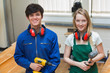 Photo: Two students holding a driller and a hammer Two students holding a driller and a hammer