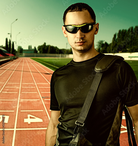 Photo: man with black sunglasses at stadium man with black sunglasses at stadium