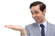 Smiling businessman looking at and showing his opened hand