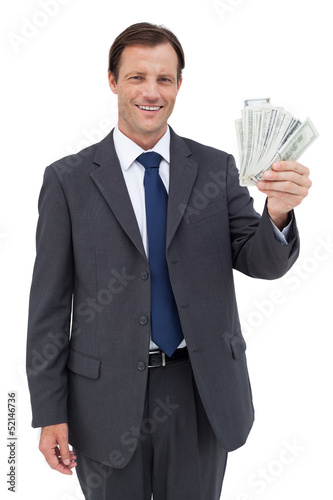 Photo: Smiling businessman holding dollar bills Smiling businessman holding dollar bills