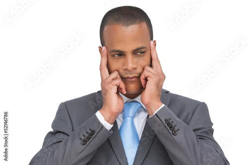 Photo: Young businessman putting his fingers on his temples Young businessman putting his fingers on his temples