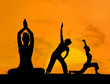 Silhouette of women doing yoga