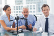 Foto: Business people having a conference together Business people having a conference together