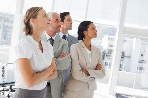 Photo: Confident business people looking at the same way Confident business people looking at the same way