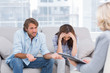 Young couple sit on the couch of the therapist