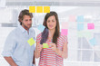 Colleagues reading sticky note