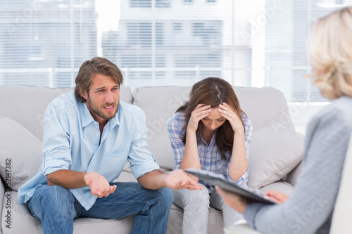 Photo: Young couple sit on the couch of the therapist Young couple sit on the couch of the therapist