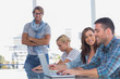Man standing with arms crossed in creative office