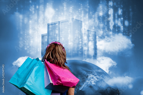 Photo: Girl with shopping bags looking at data server on top of earth Girl with shopping bags looking at data server on top of earth