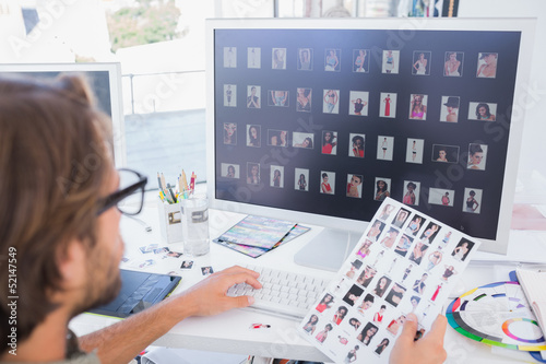 Photo: Photo editor working on the contact sheet Photo editor working on the contact sheet