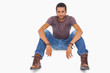 Handsome man sitting on floor