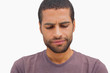 Handsome man frowning and looking down