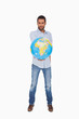 Foto: Serious man holding out a globe Serious man holding out a globe