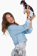Happy woman lifting her chihuahua