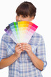 Pretty woman with fringe showing colour charts