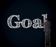 Foto: Businessman writing goal on a giant blackboard Businessman writing goal on a giant blackboard