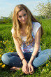 Photo: Young woman enjoying the spring between dandelions Young woman enjoying the spring between dandelions
