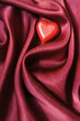 Small heart on a satin sheet