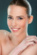 Photo: Beautiful woman smiling, close up over a dark background Beautiful woman smiling, close up over a dark background