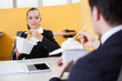 Photo: Business people eating chinese food in the office Business people eating chinese food in the office