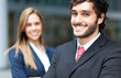 Photo: Two business people outdoor smiling Two business people outdoor smiling