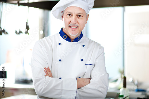 Photo: Male chef working in a restaurant kitchen Male chef working in a restaurant kitchen